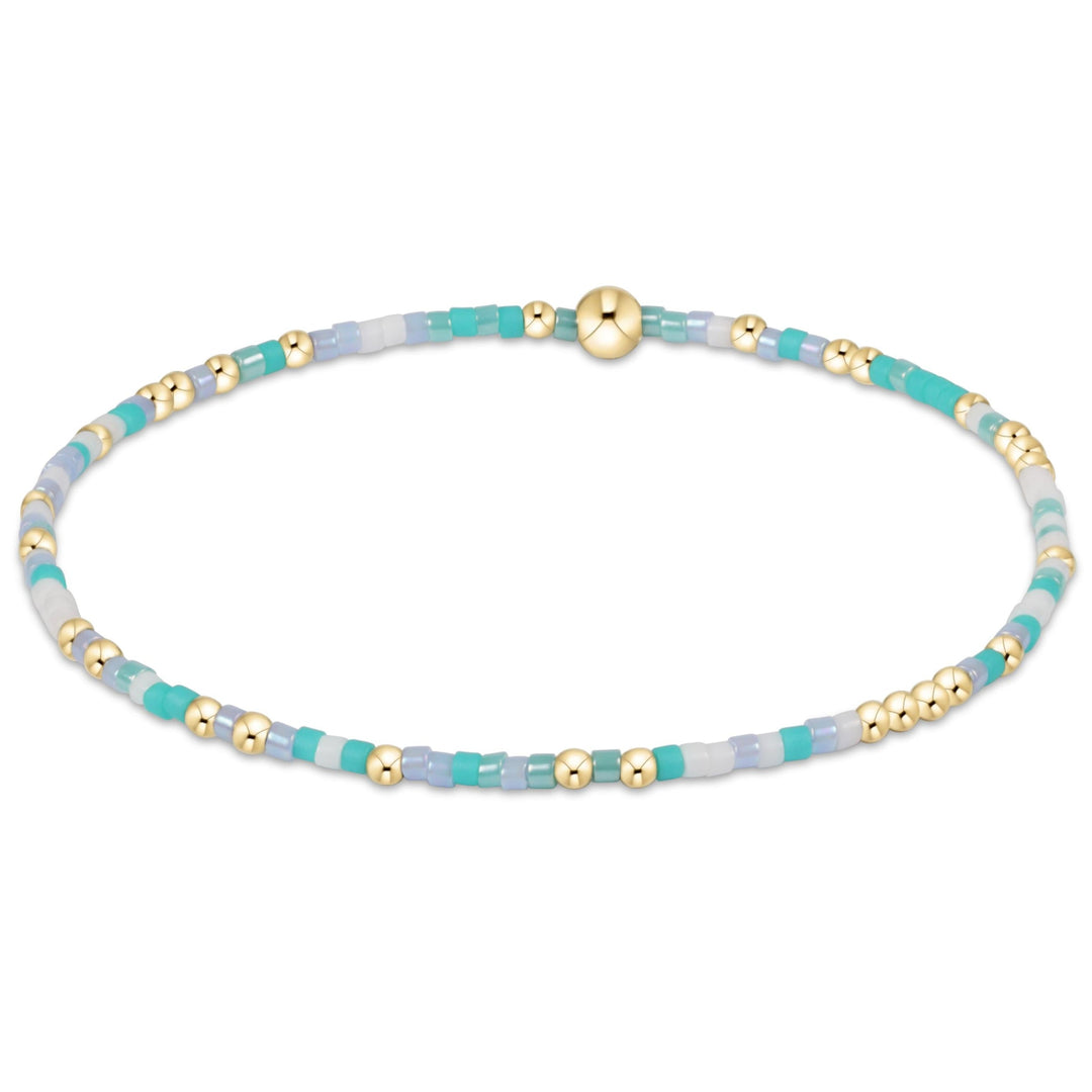 Egirl Hope Unwritten bracelet featuring gold-filled beads with multi-colored seed bead accents on stretch elastic.