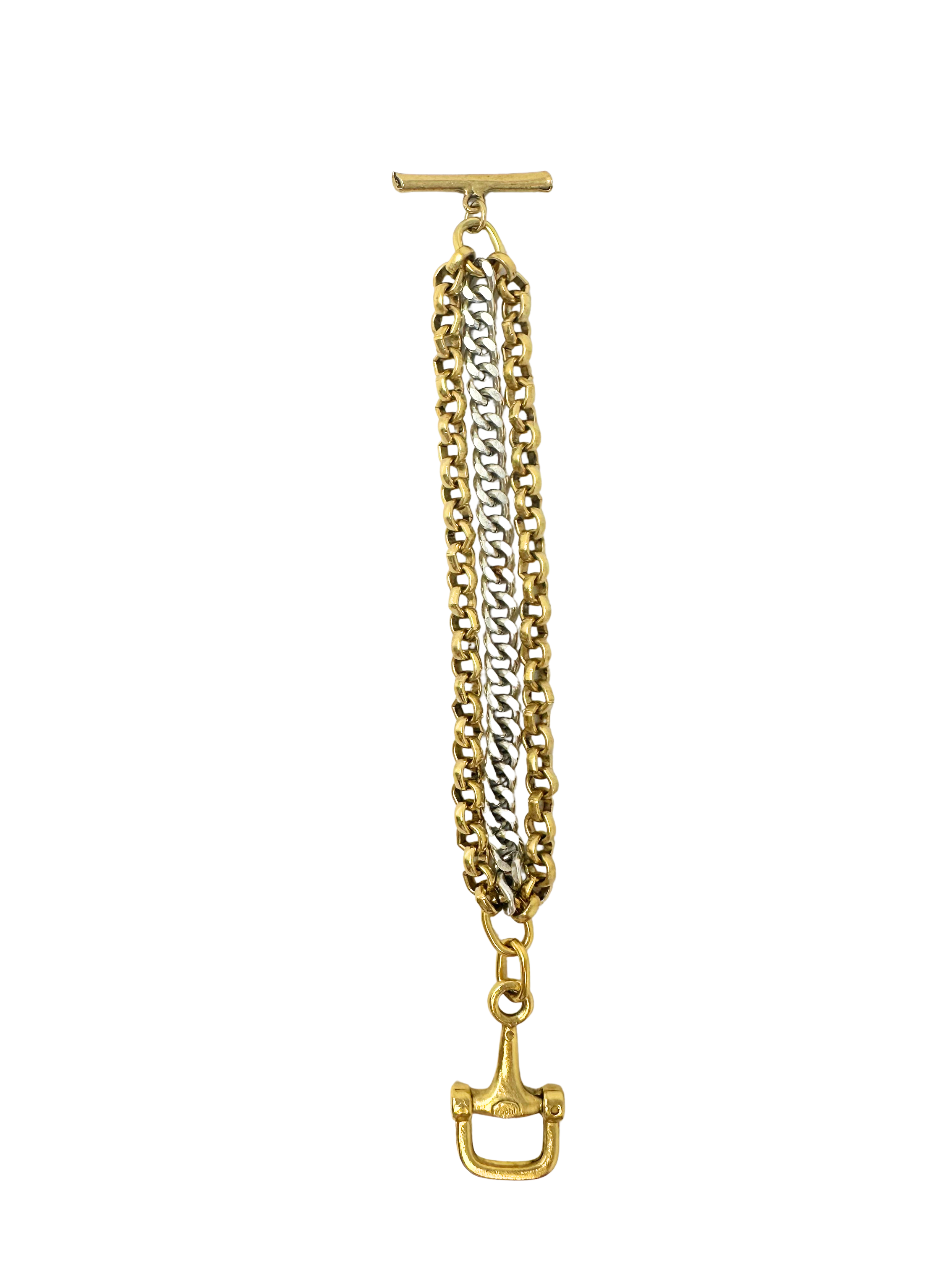 Two-tone gold and silver triple chain bracelet with a toggle clasp and stirrup charm.
