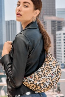 Leopard print parachute nylon swing bag with adjustable strap and zip top closure.
