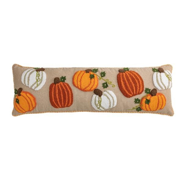 Long cotton pillow with tufted pumpkin patterns and striped piping in warm autumn tones.