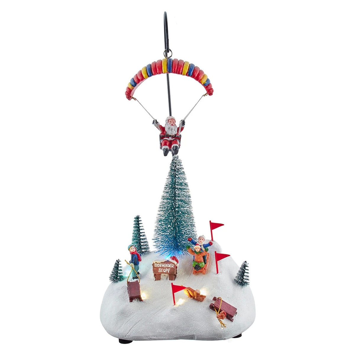 13.2" musical LED Christmas scene with Santa parachuting over a snowy hill with skiing children.
