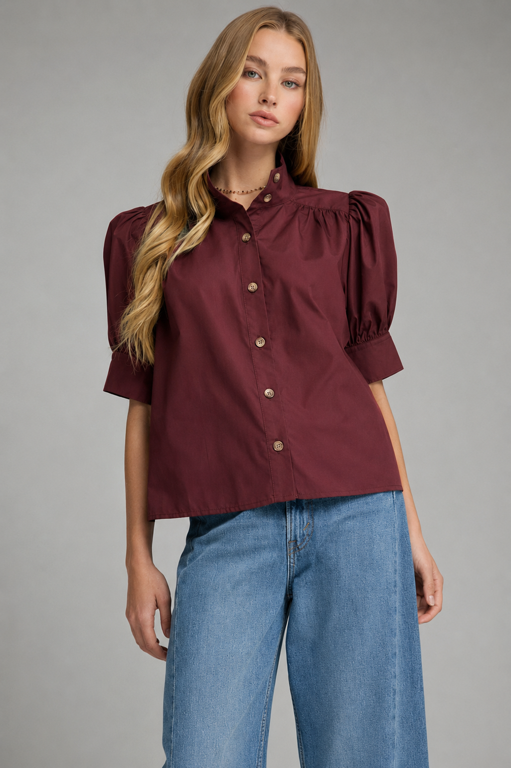 Delia T32670 Top in burgundy with short puff sleeves, button front, and collar detail.