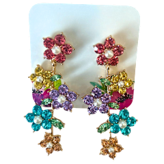 Gold toned studded earrings featuring five cascading crystal flowers in pink, yellow, purple, teal, and peach.