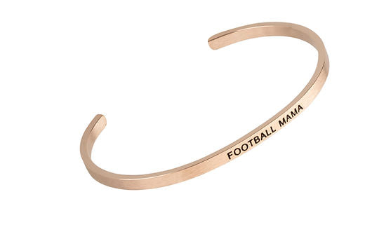 Rose gold cuff bracelet engraved with the words FOOTBALL MAMA in black capital letters.