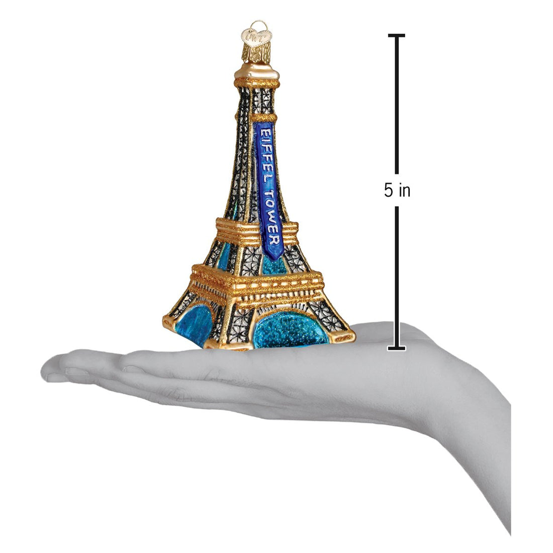 Eiffel Tower glass ornament in blue and gold, 5 inches tall, held in a hand for scale.