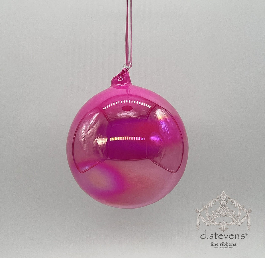 150mm hand-blown hot pink iridescent glass ball ornament hanging from a matching ribbon.