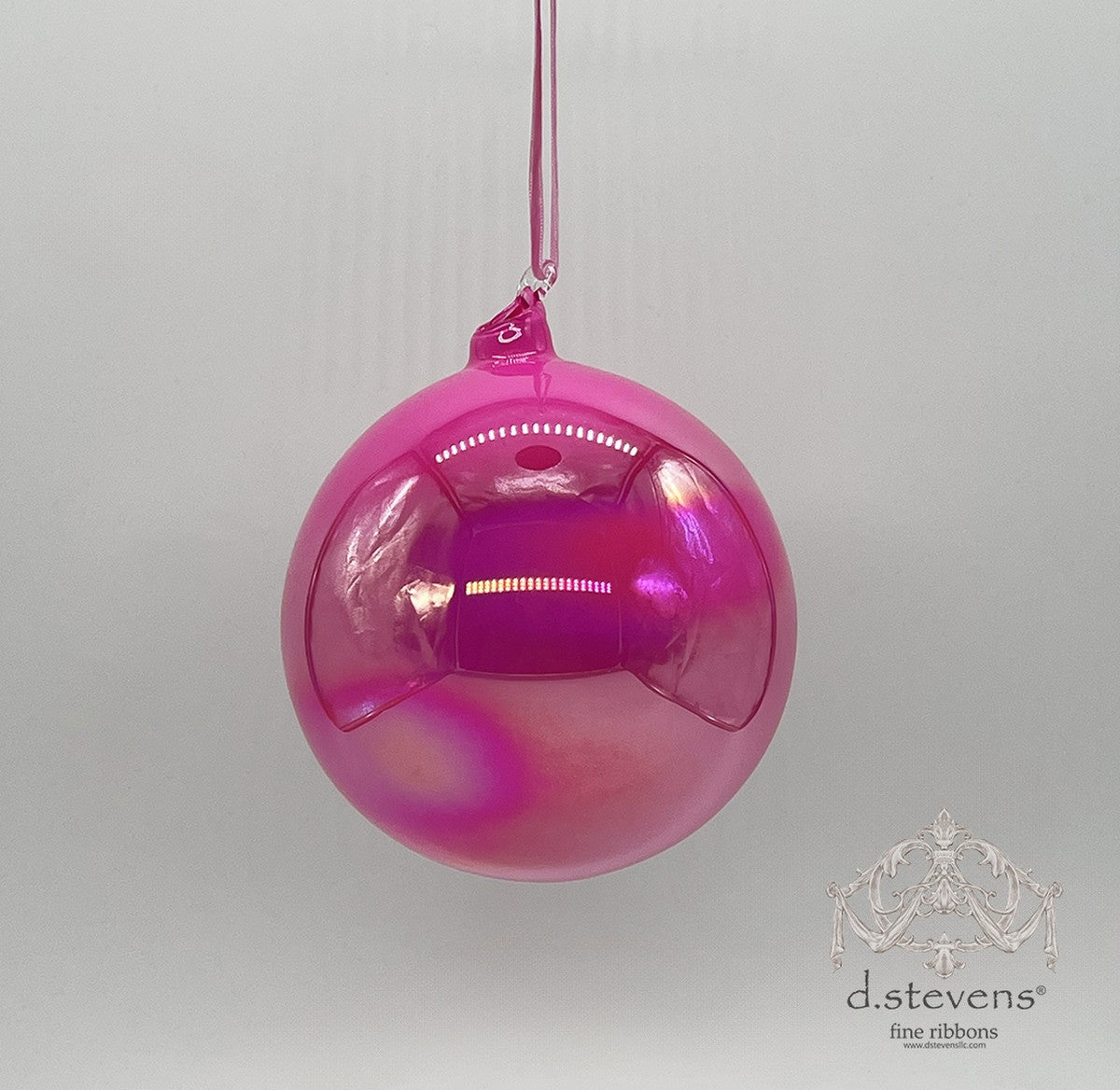 150mm hand-blown hot pink iridescent glass ball ornament hanging from a matching ribbon.