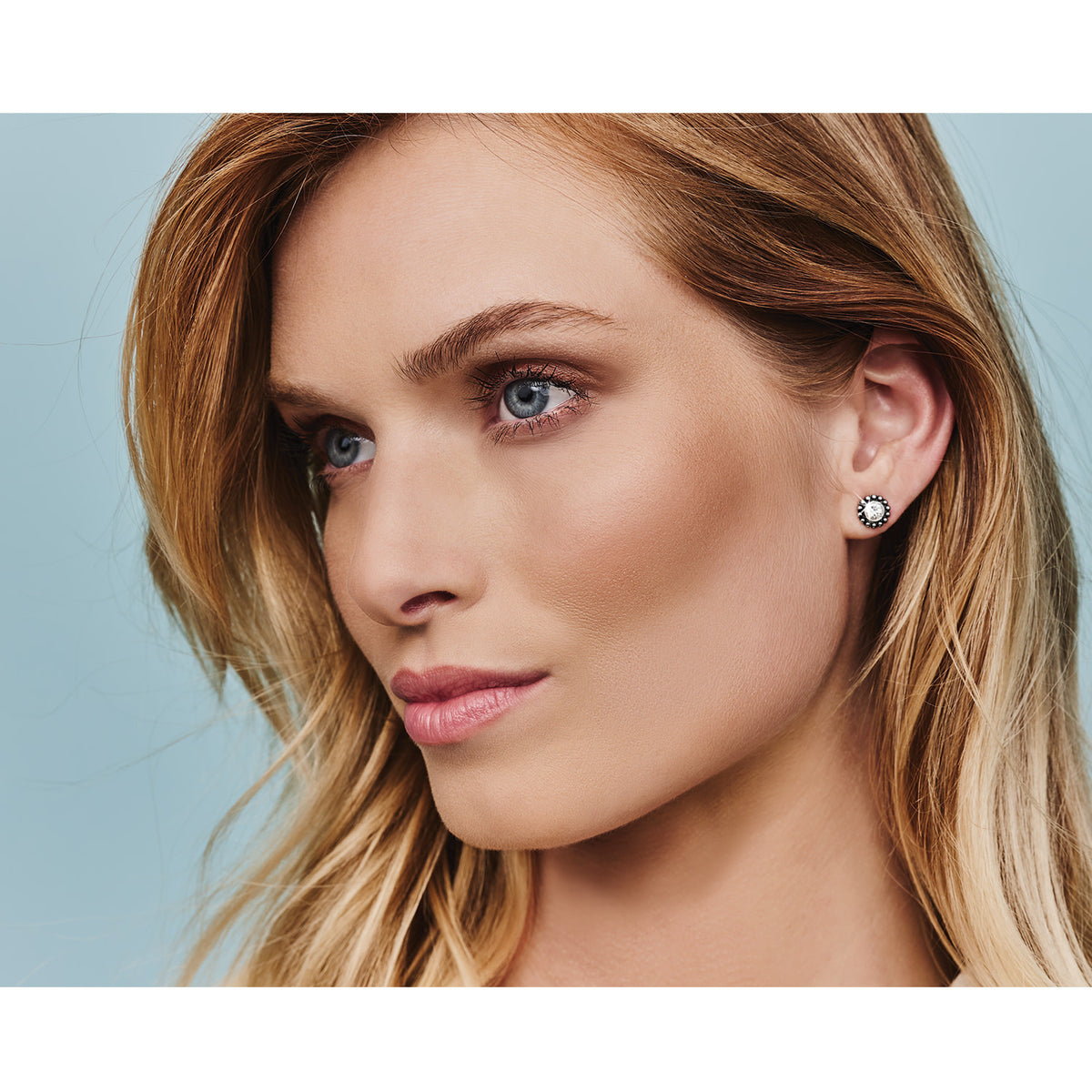 Silver plated mini post earrings featuring a quarter-inch drop with fine quality crystal accents.