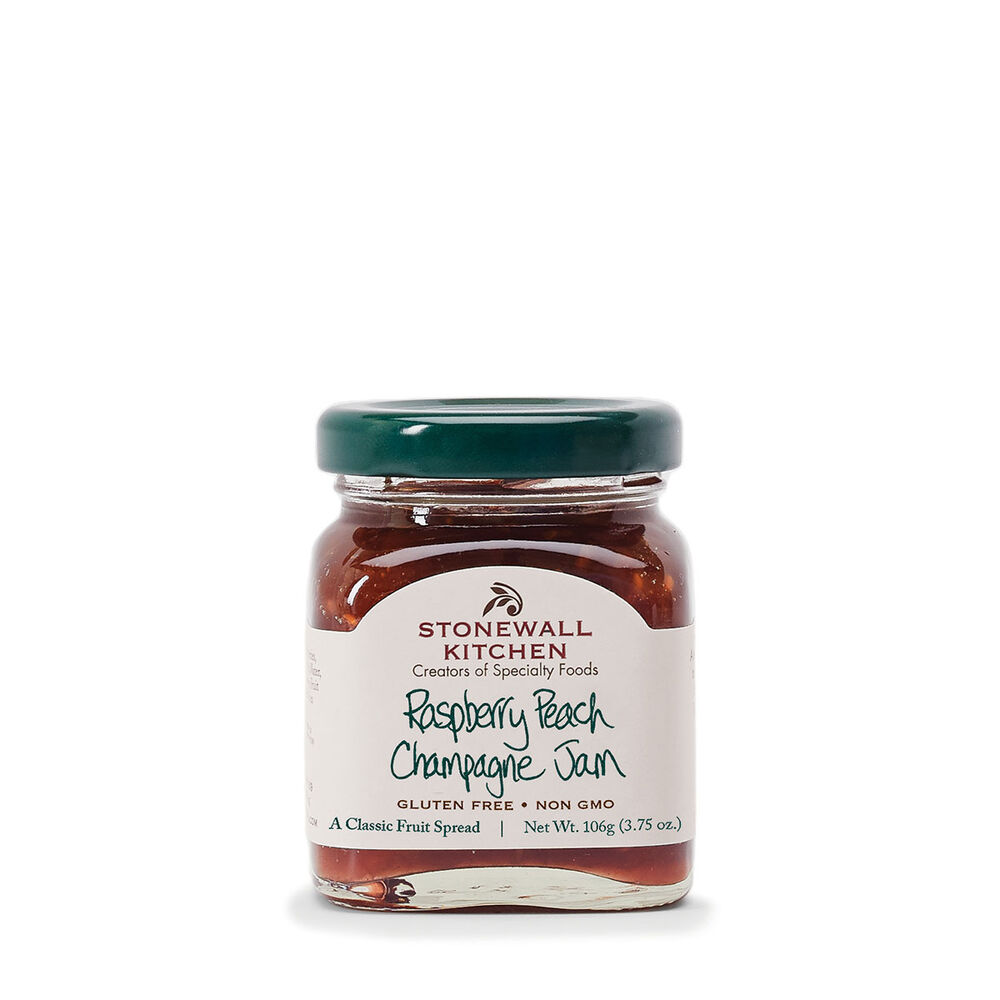 A 3.75oz jar of Stonewall Kitchen Raspberry Peach Champagne Jam with a green lid.