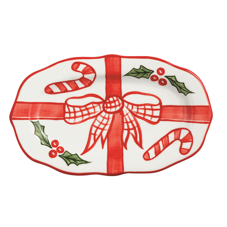 Oval ceramic Holly Everything Plate with hand-painted red bow, candy canes, and holly leaves.