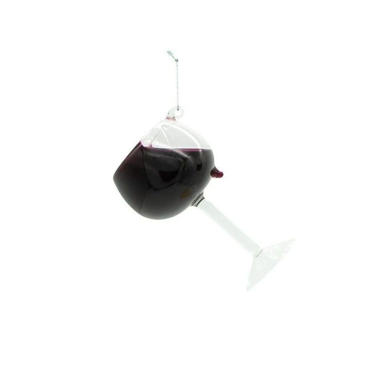 Glass wine glass Christmas ornament filled with dark red liquid, hanging from a silver string.