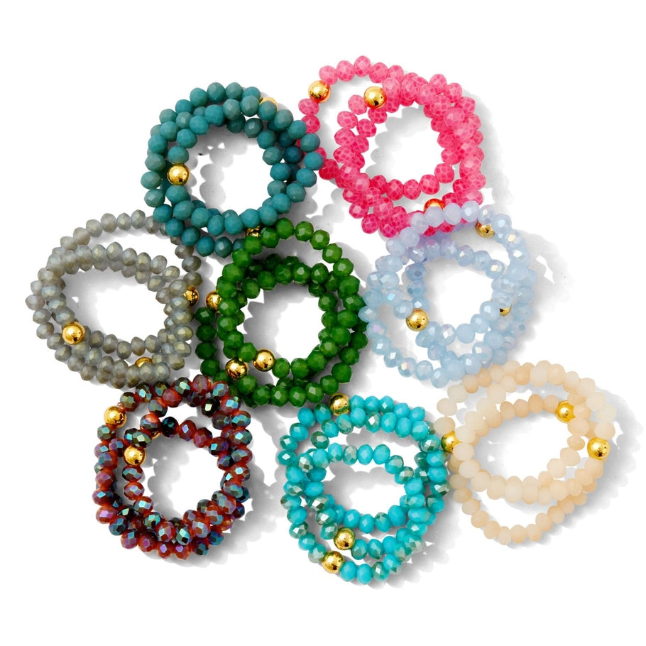 Gold-plated brass stretch ring with glass crystals in a circular band.