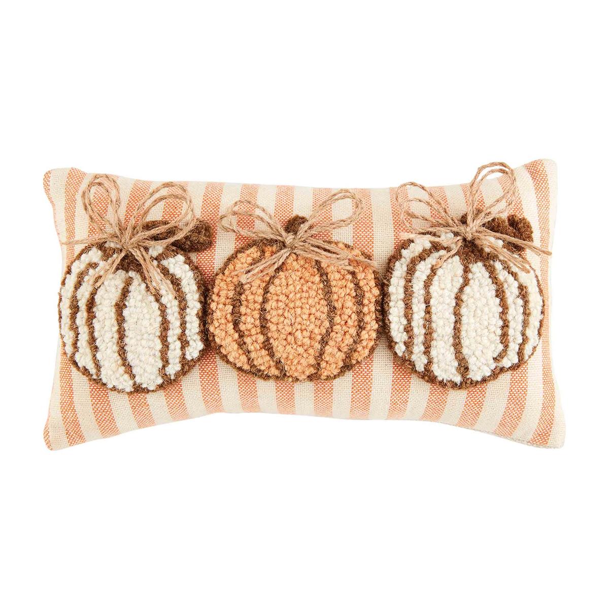 Two gathered wool pillows featuring a pumpkin leaf print in earthy tones.