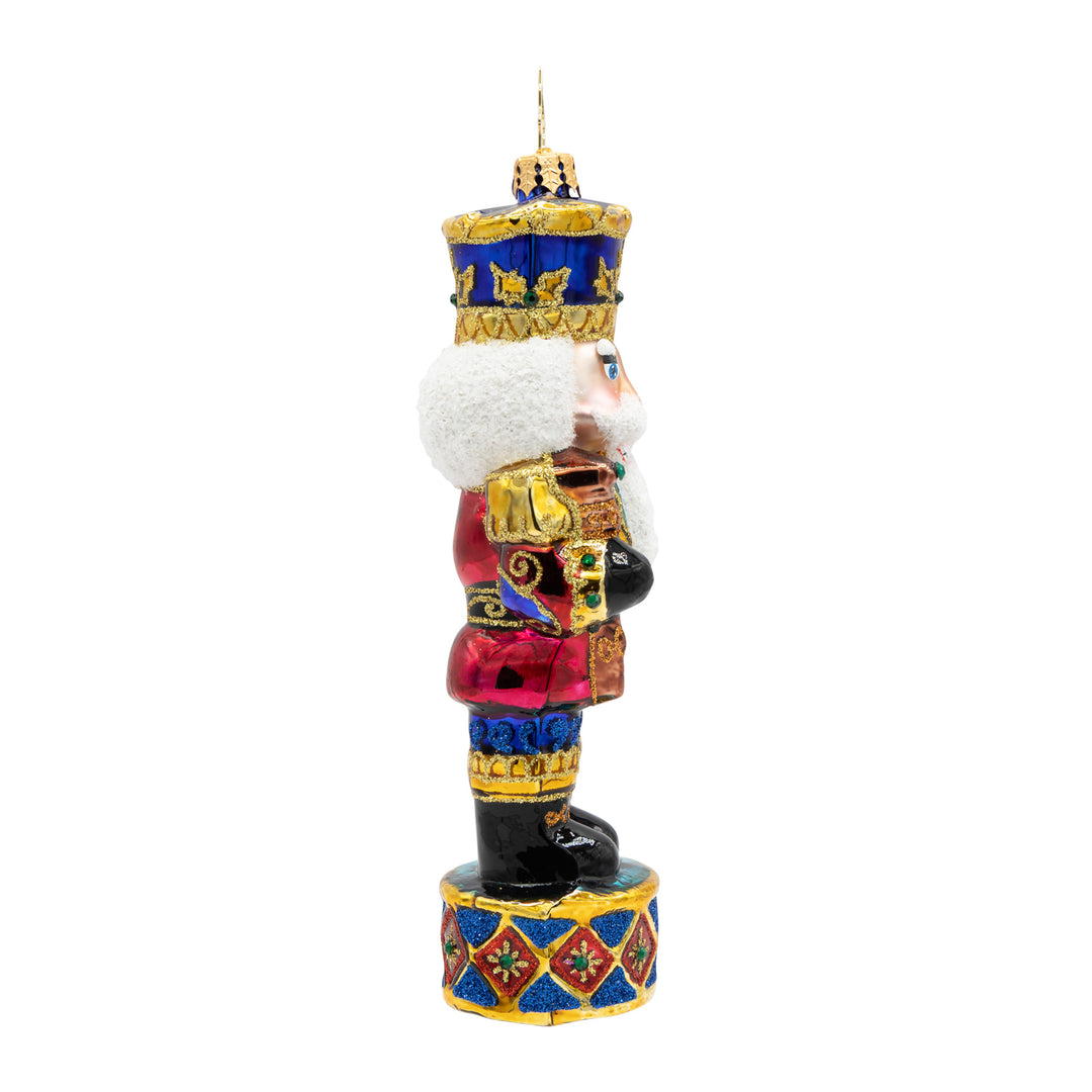 Radiant Jewel Nutcracker glass ornament in ruby, sapphire, and gold with a glittery white beard.