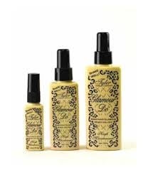 Three yellow spray bottles of Tyler Glamour Do in varying sizes with black leopard print labels.