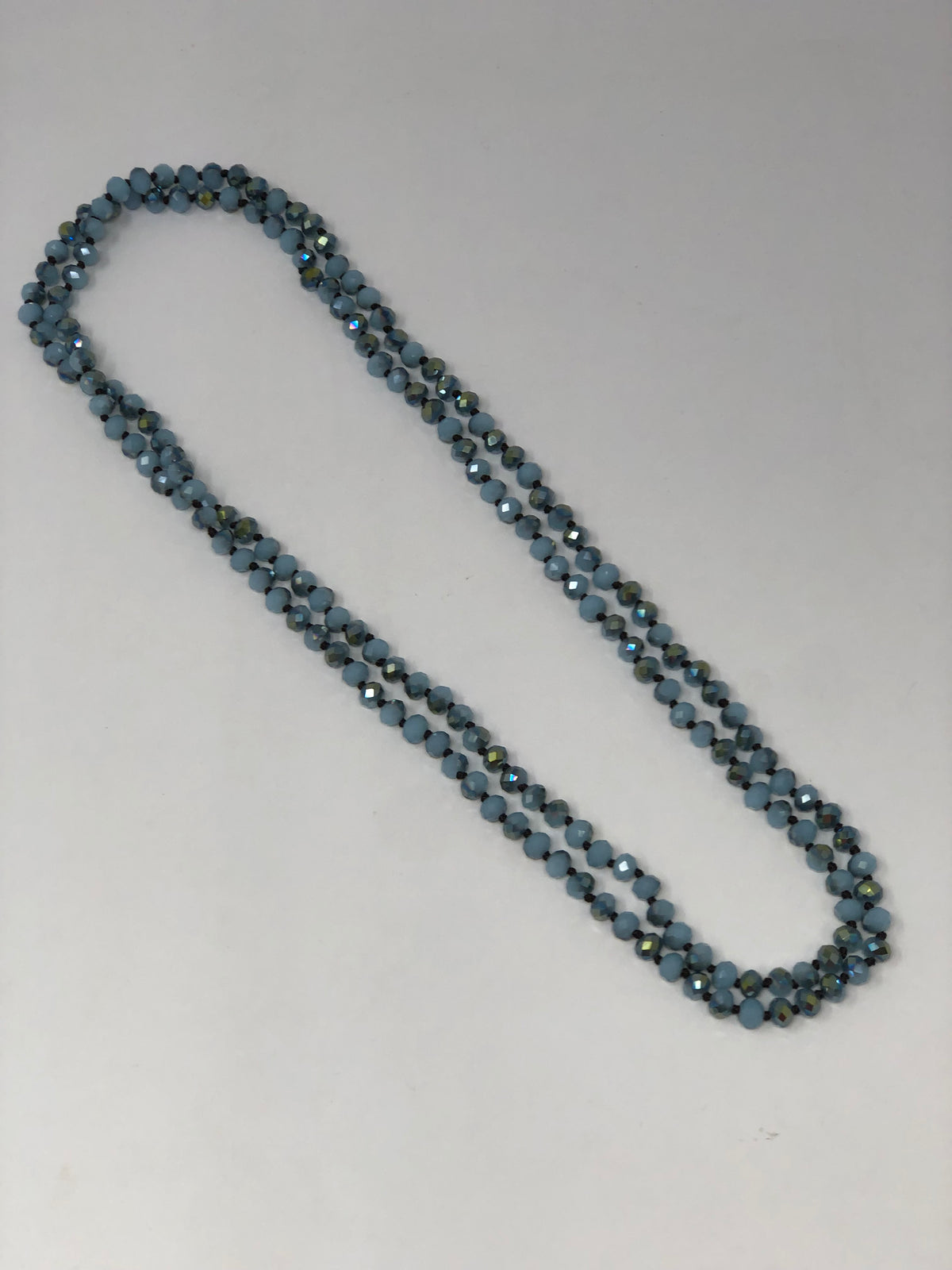 60-inch dark brown crystal beaded necklace with knotting between beads and no clasp