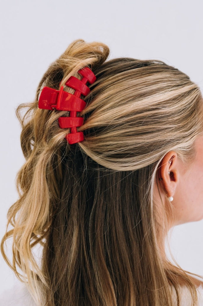 Medium-sized classic hair clip in a neutral tone with smooth plastic finish.