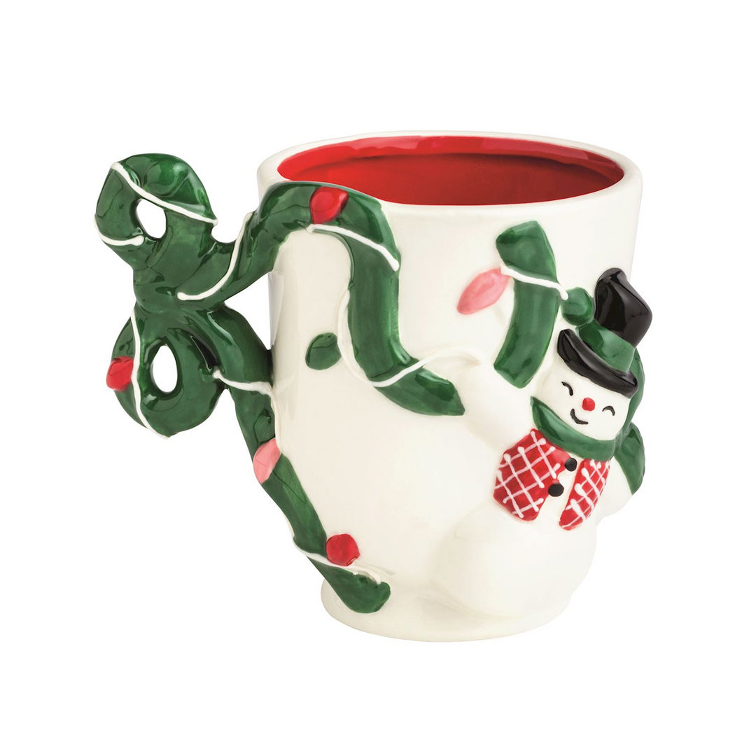 Hand-painted ceramic Bow Christmas Mug with a snowman, green garland, and a bow-shaped handle.