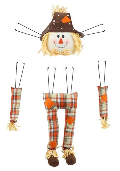 Scarecrow Decor Kit with a smiling head, two arms, and legs in orange and green plaid with patches.