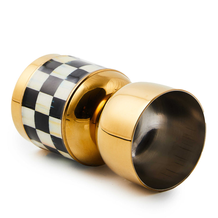 Double-sided stainless steel jigger with gold enamel coating in Courtly Check pattern.