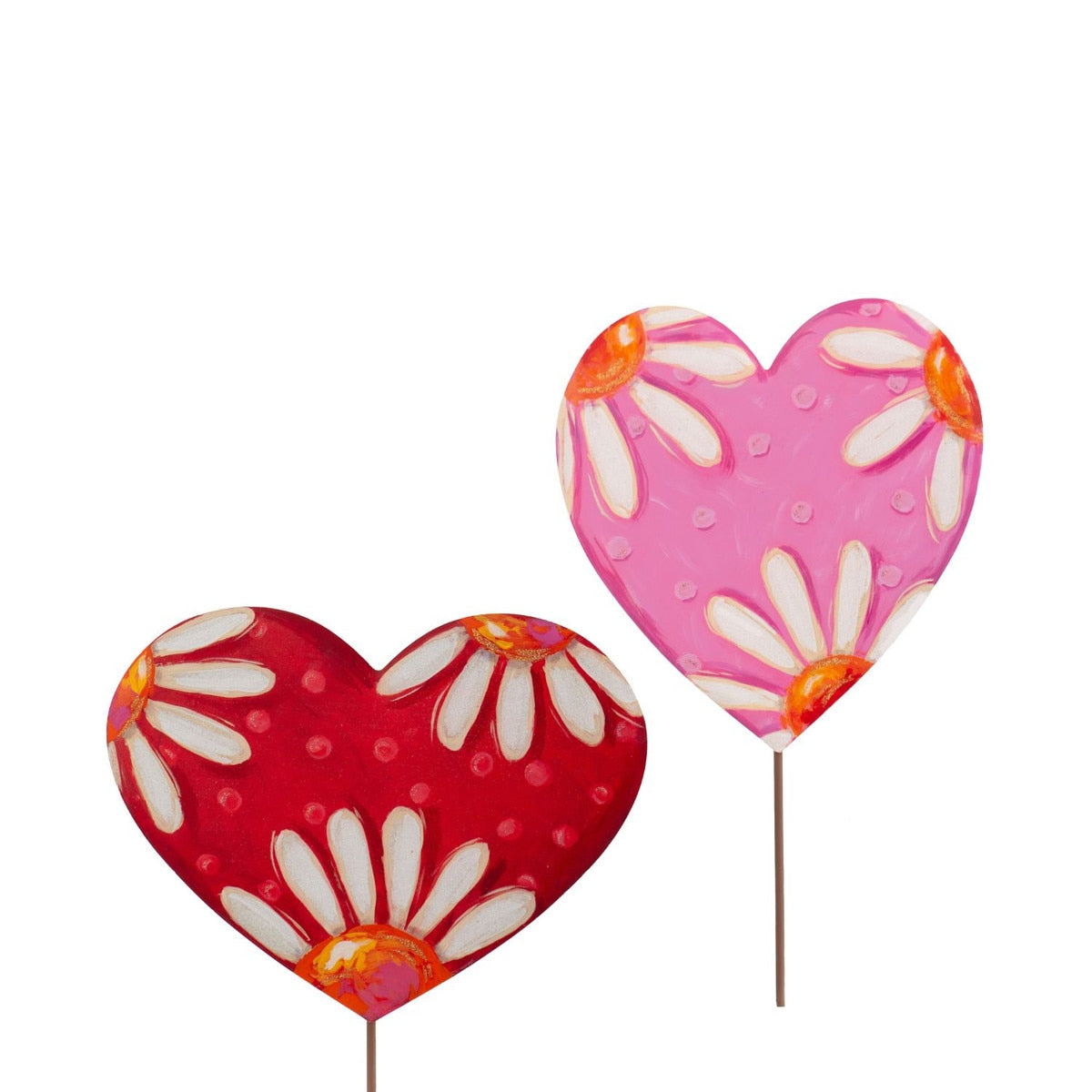 Two heart-shaped garden stakes, one red with white polka dots and daisies, the other pink with white polka dots and daisies.