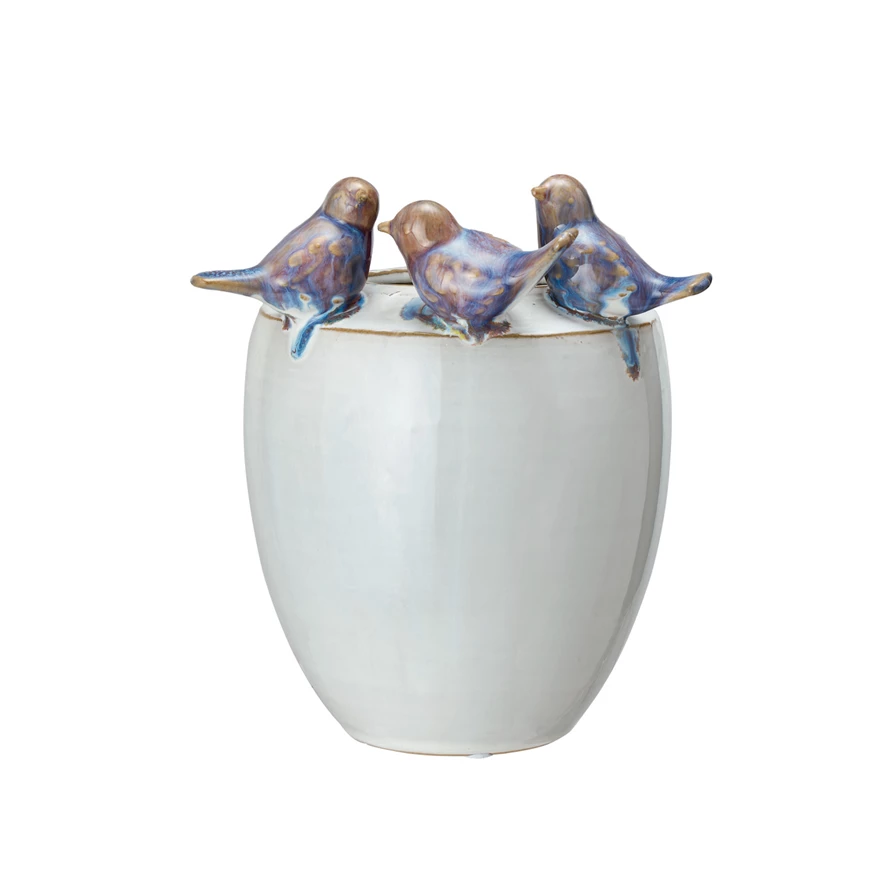 Oval stoneware planter with reactive glaze finish holding a small plant