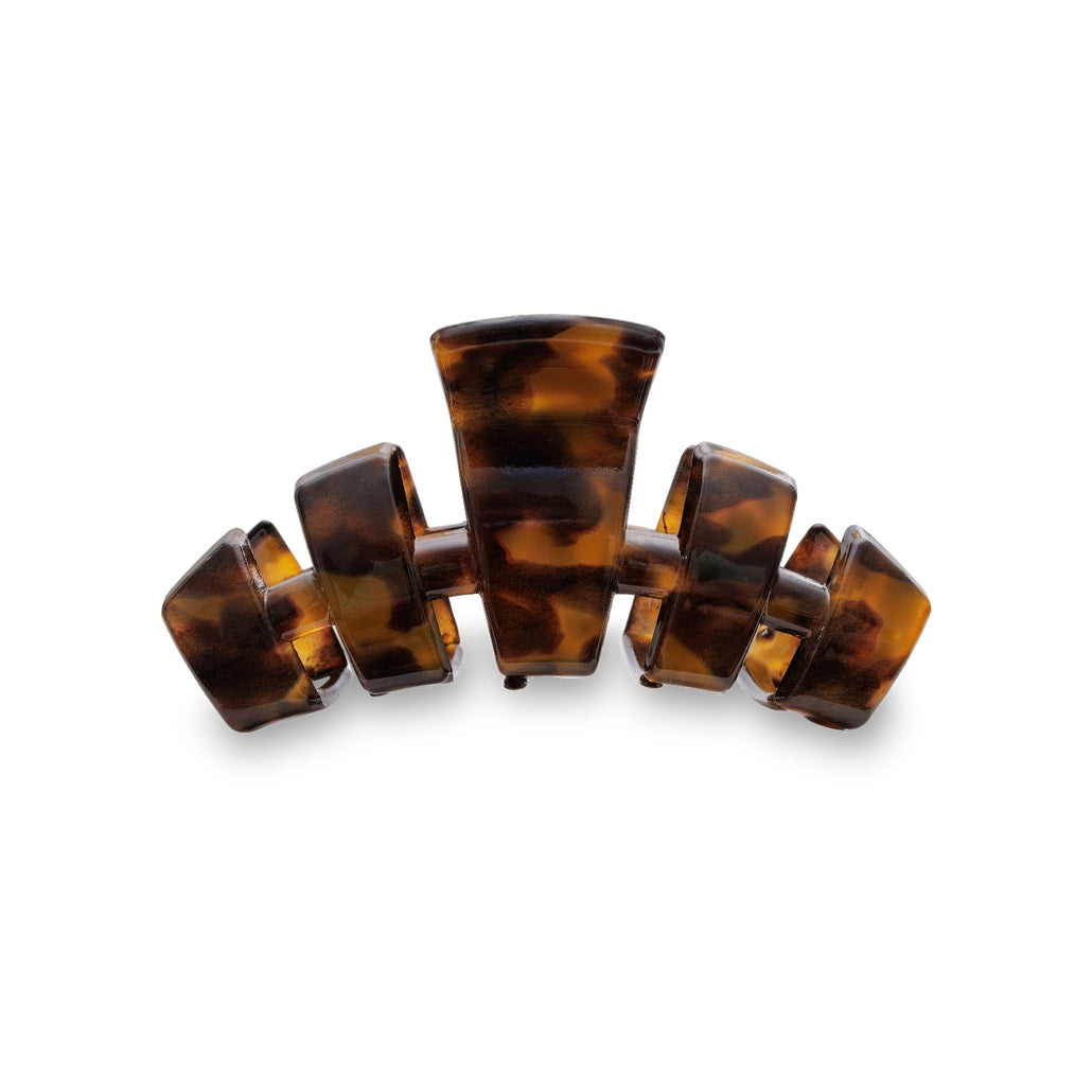 Small classic hair clip with bendable teeth in a neutral tone.