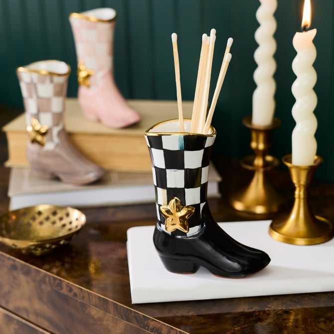 Hand-painted black and white checkered cowboy boot bud vase with a gold star and matches inside.