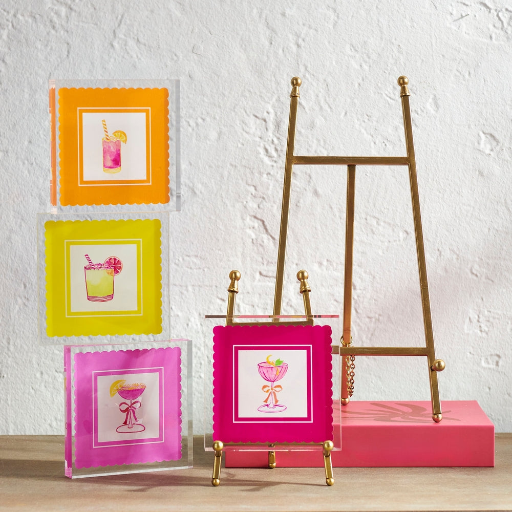 Gold iron easel holding artwork with a classic vertical silhouette.