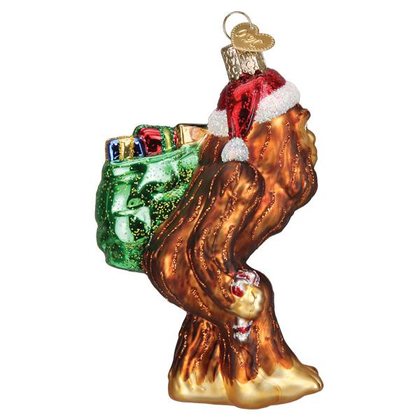 Glass Santa Sasquatch ornament wearing a red hat and carrying a green sack of gifts.