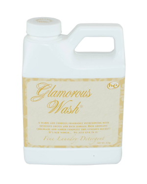 Bottle of Glamorous Wash laundry detergent in a clear container with blue liquid.