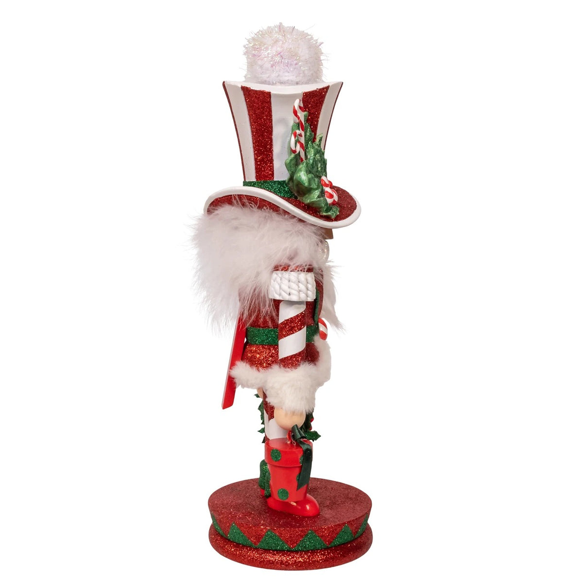 Side view of a 15-inch Hollywood Mr. Christmas Nutcracker in a red and white striped glitter outfit.