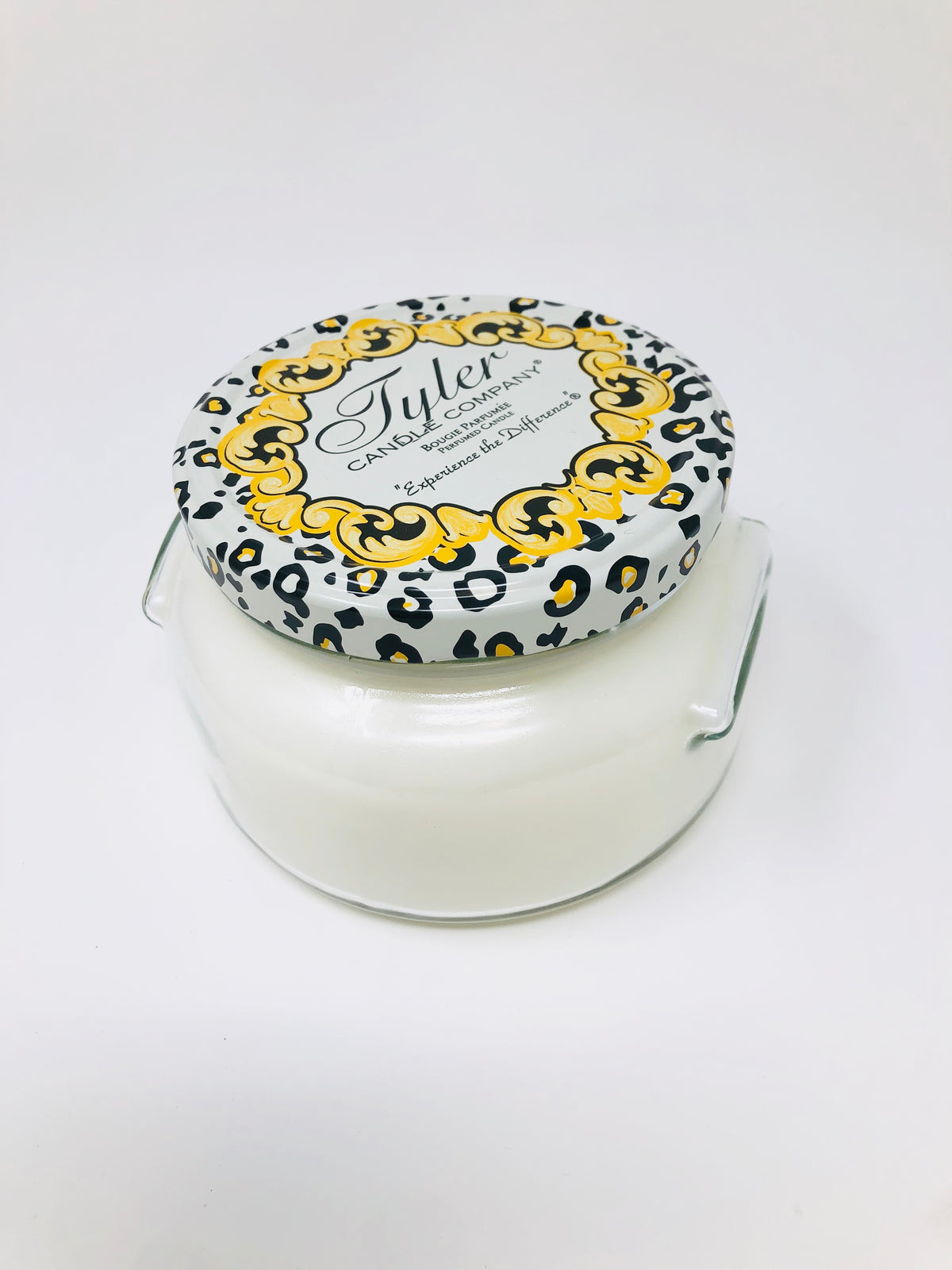 A large 22oz Tyler candle in a clear glass jar with an off-white wax and black wick.