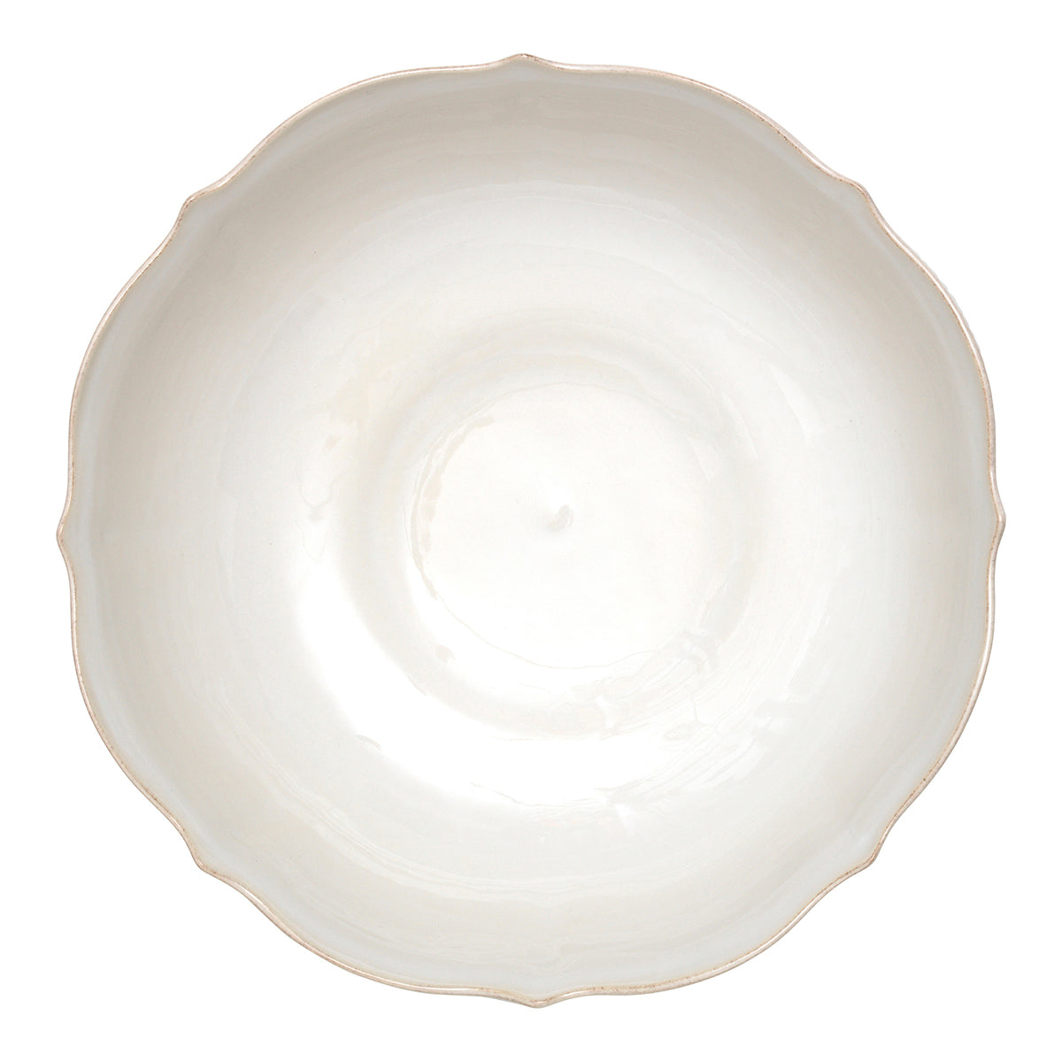 Top view of a Berry & Thread whitewash ceramic footed fruit bowl with a scalloped rim.