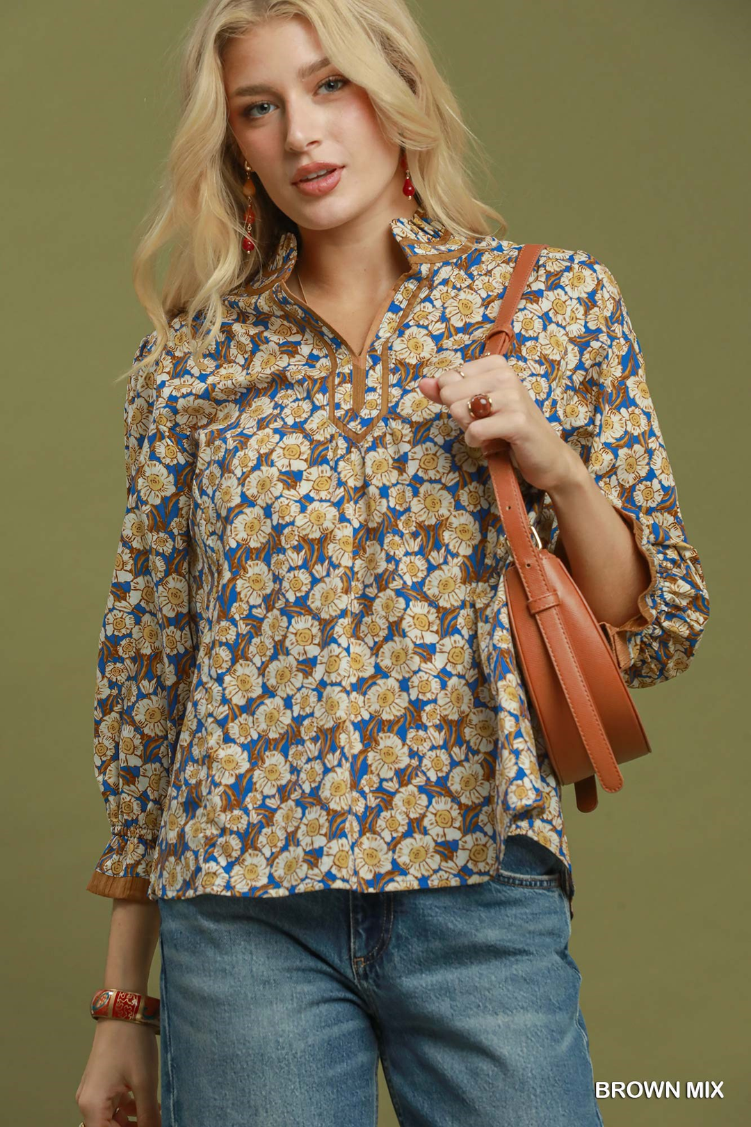 Woman wearing a blue and brown Kate Mix Floral Print Mandarin Collar Blouse with denim jeans.