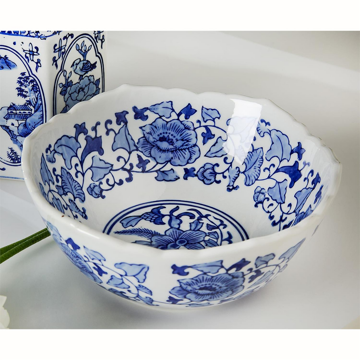 Blue and white Canton ceramic bowl with traditional floral patterns and a scalloped rim.