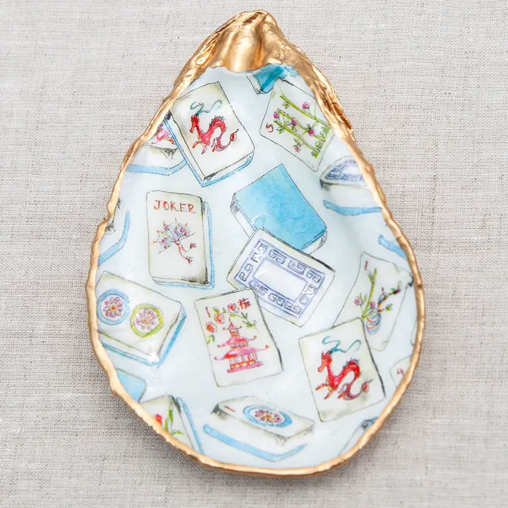 Decoupaged oyster shell with mahjong tile pattern and metallic gold trim.