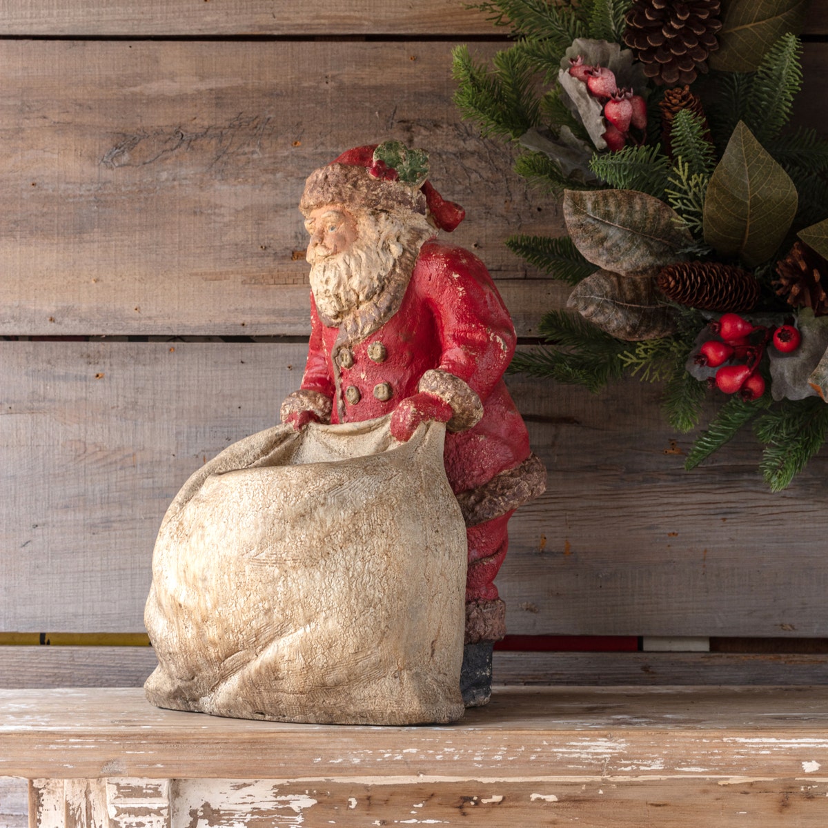 Vintage Santa Claus figurine holding a gift bag