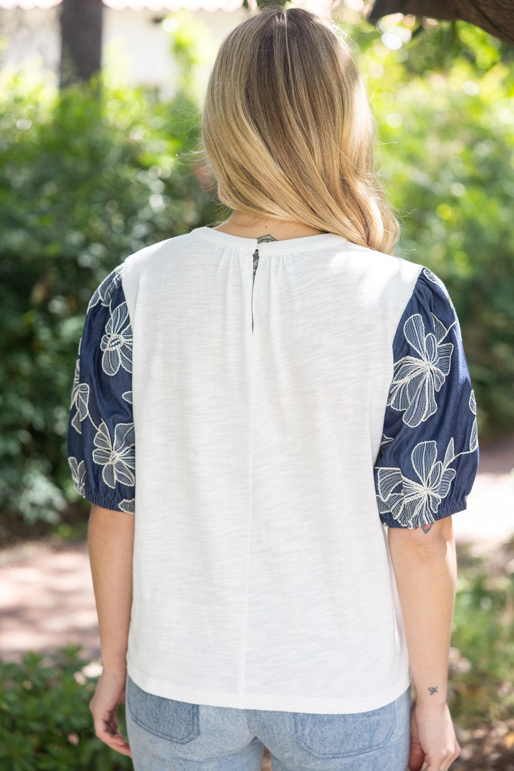 Floral embroidered puff sleeve slub knit top in light pink with a feminine silhouette.