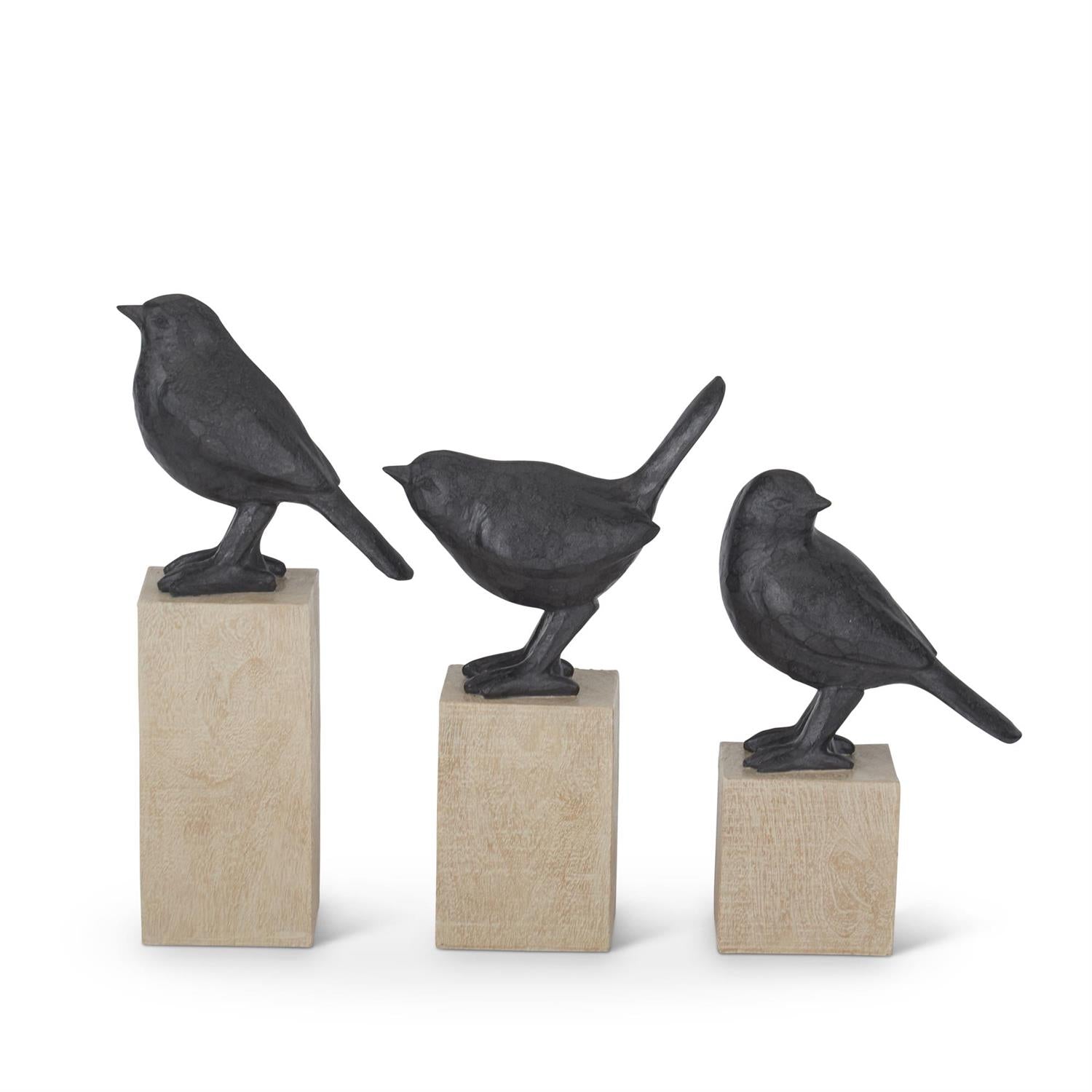 Three resin faux cast iron bird figurines on light wood block pedestals in varying heights.