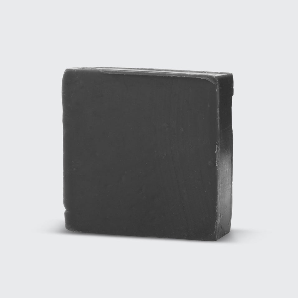 Charcoal Detoxifying Body Wash Bar in a solid bar format with dark gray color and natural texture.