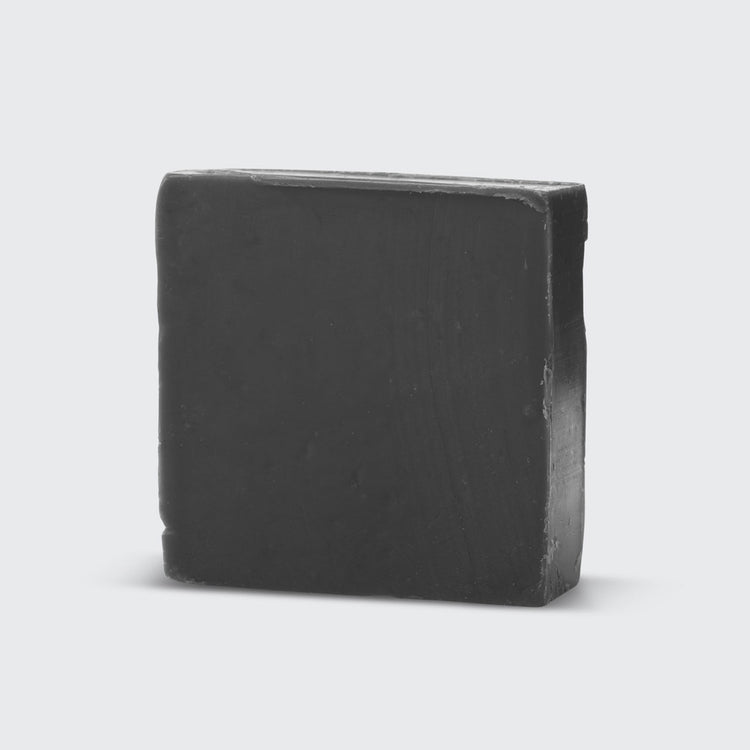 Charcoal Detoxifying Body Wash Bar in a solid bar format with dark gray color and natural texture.