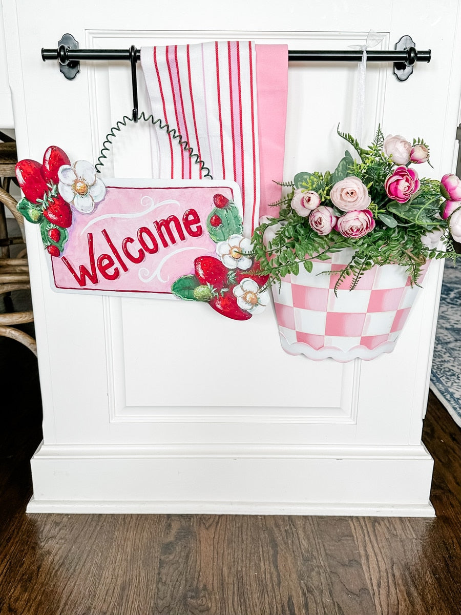 Pink ric rac pocket with gingham pattern and floral accents.