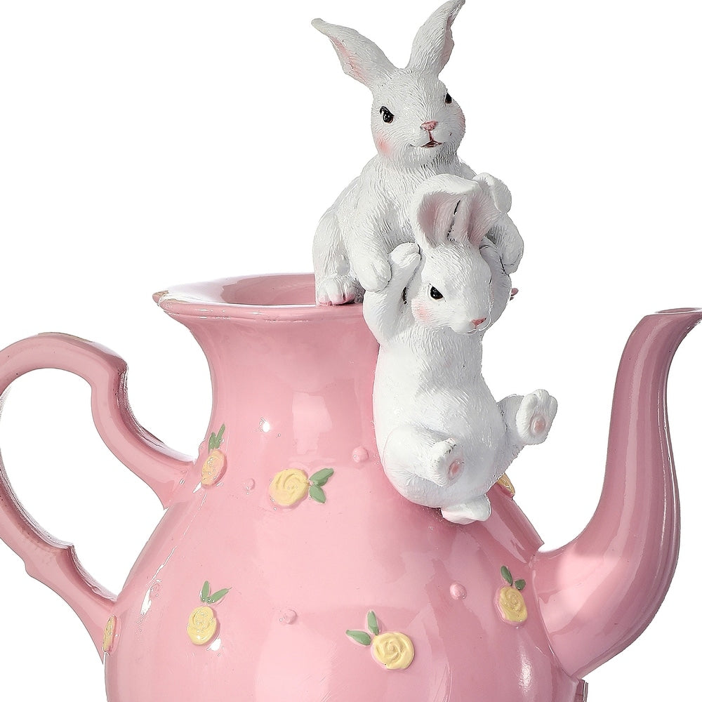 Resin tea pot with playful bunny figures in white against a neutral background.