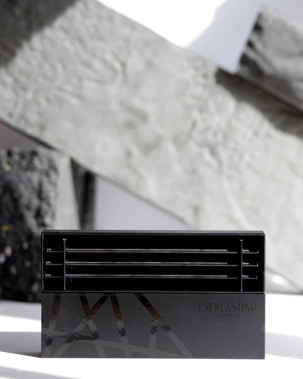Black steel candle holder with an eight-inch tall cylindrical shape.