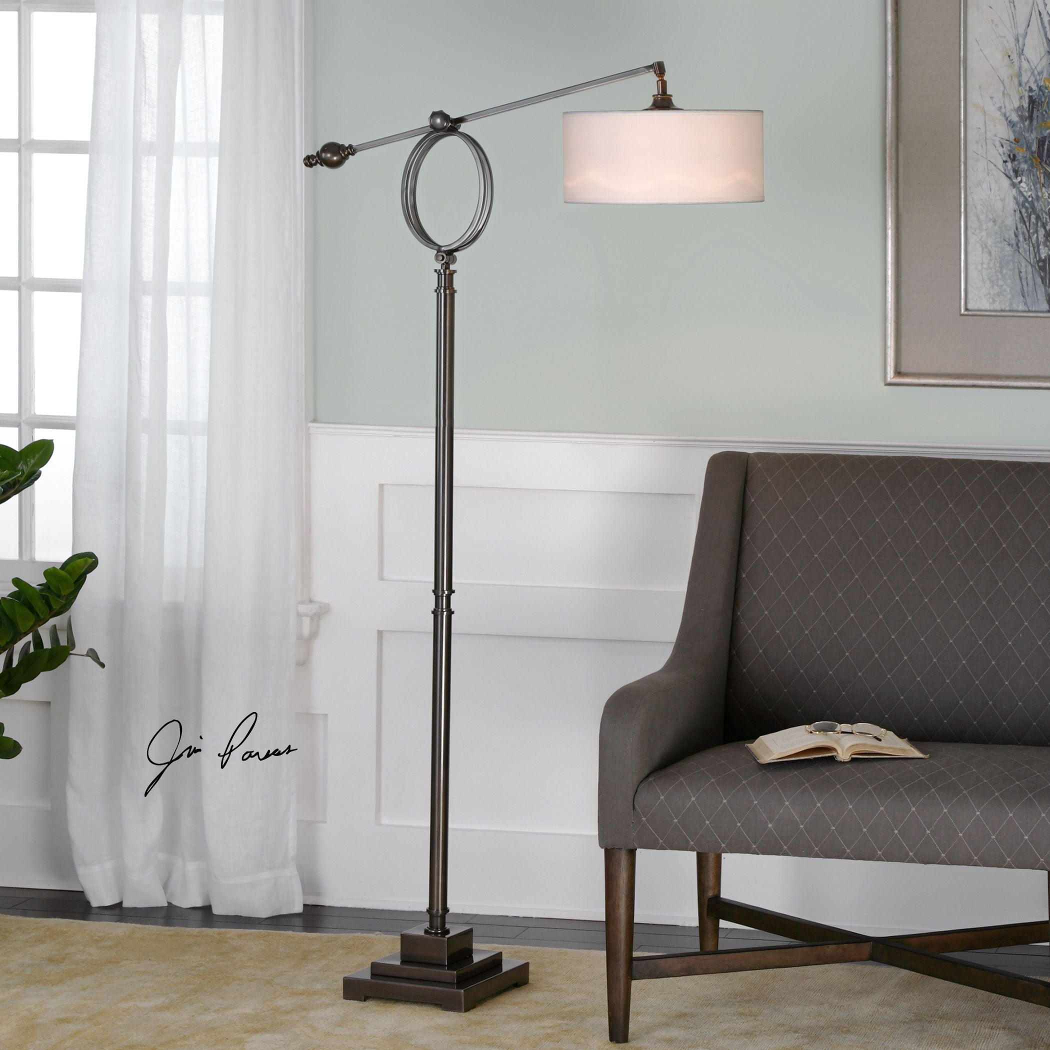 Levisa brushed bronze floor lamp with a tall slender silhouette and cylindrical shade.