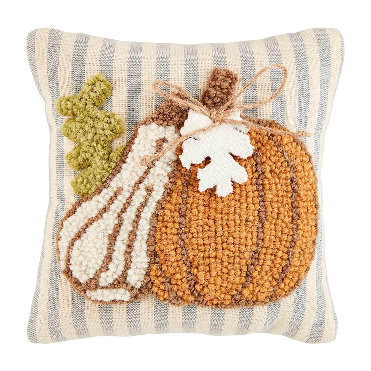 Two hook wool gather pillows featuring a pumpkin leaf print in earthy tones with gathered fabric tops.