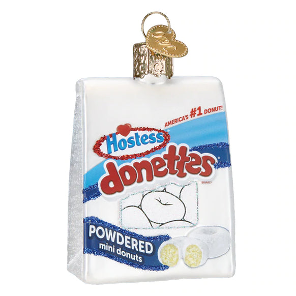 Glass ornament shaped like a Hostess Donettes donut with pink frosting.