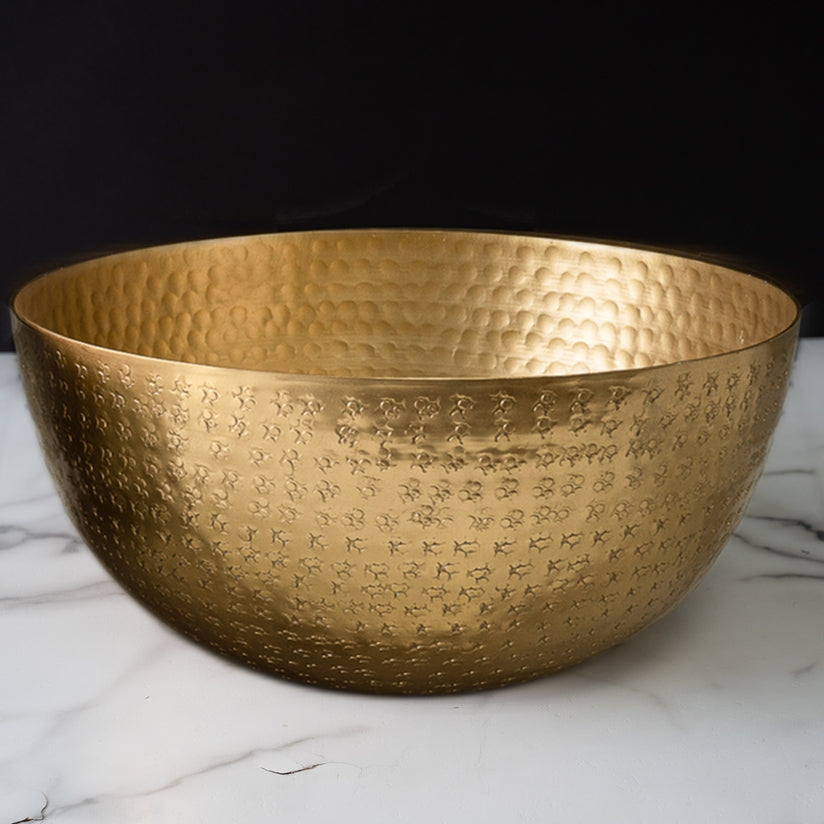 Gold aluminum hammered bowl with a textured surface