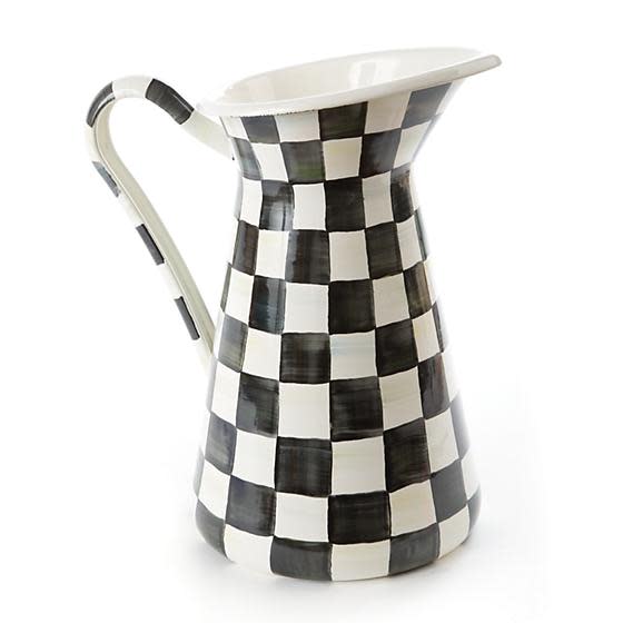 Large hand-painted black and white checkered enamel pitcher with a curved handle.